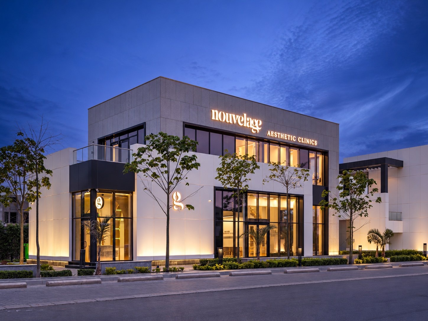 The Nouvelage clinic at dusk, sign lit